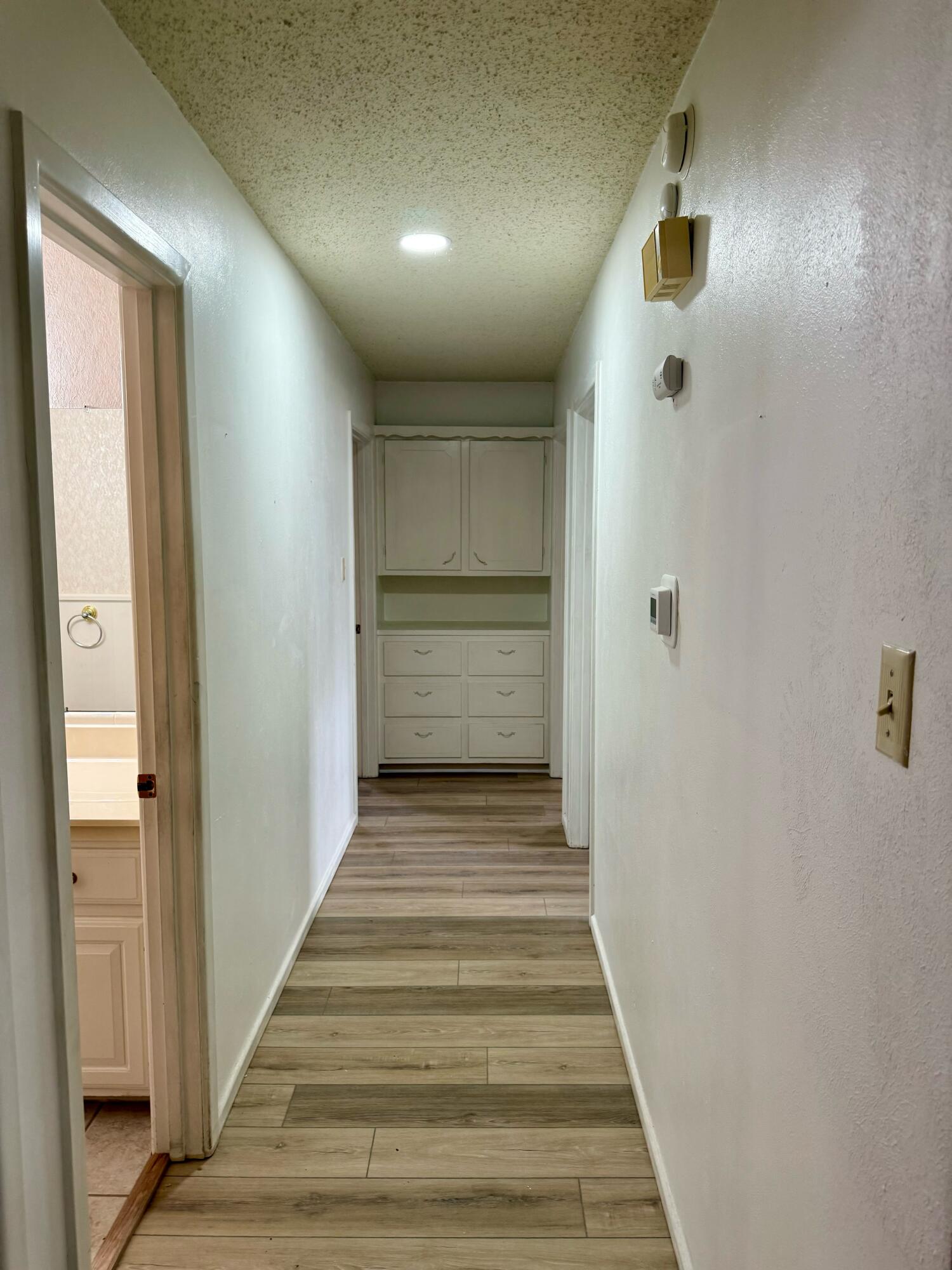 3012 69th Street Lubbock, TX 79413 - Photo 17 of 38 a view of a hallway with wooden floor and entryway