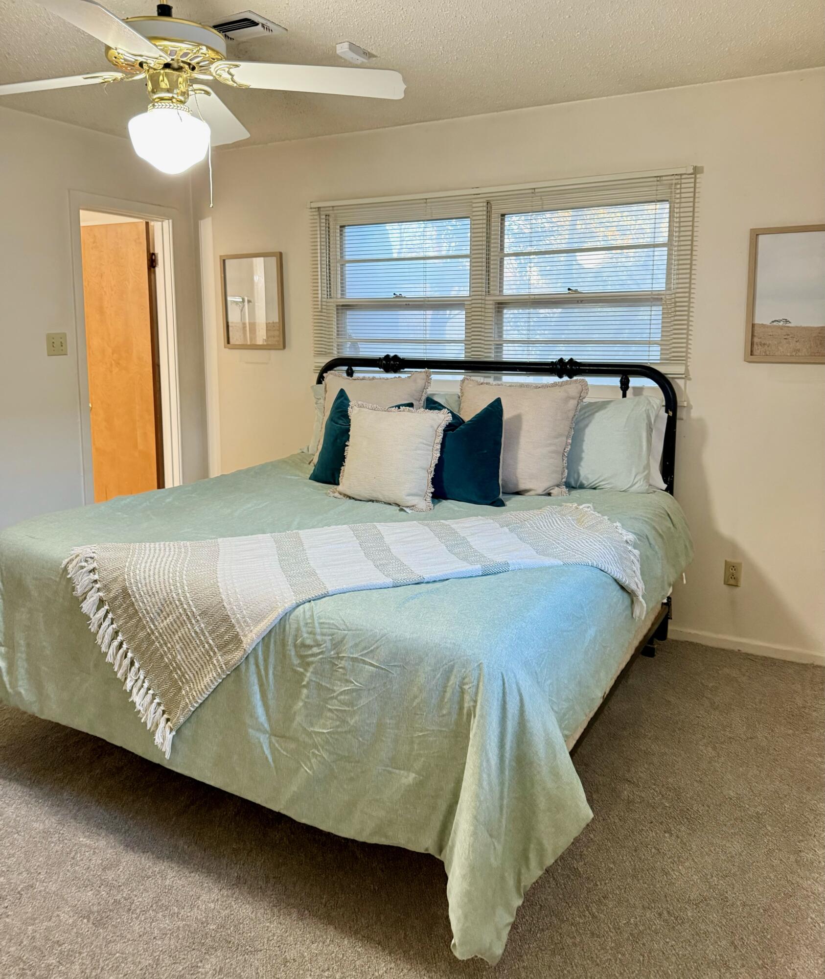3012 69th Street Lubbock, TX 79413 - Photo 19 of 38 a bedroom with a bed and wooden floor