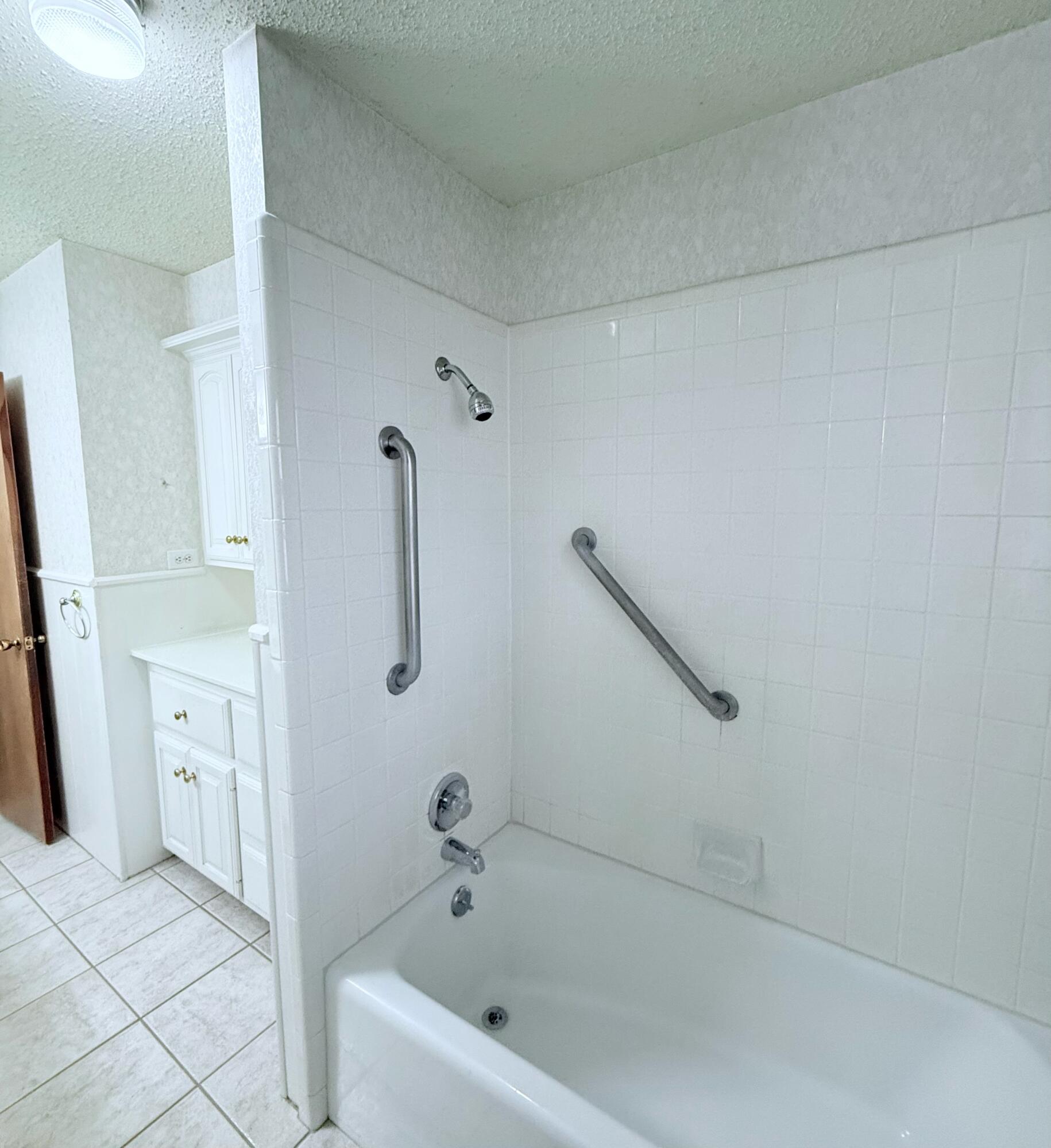 3012 69th Street Lubbock, TX 79413 - Photo 24 of 38 a bathroom with a tub
