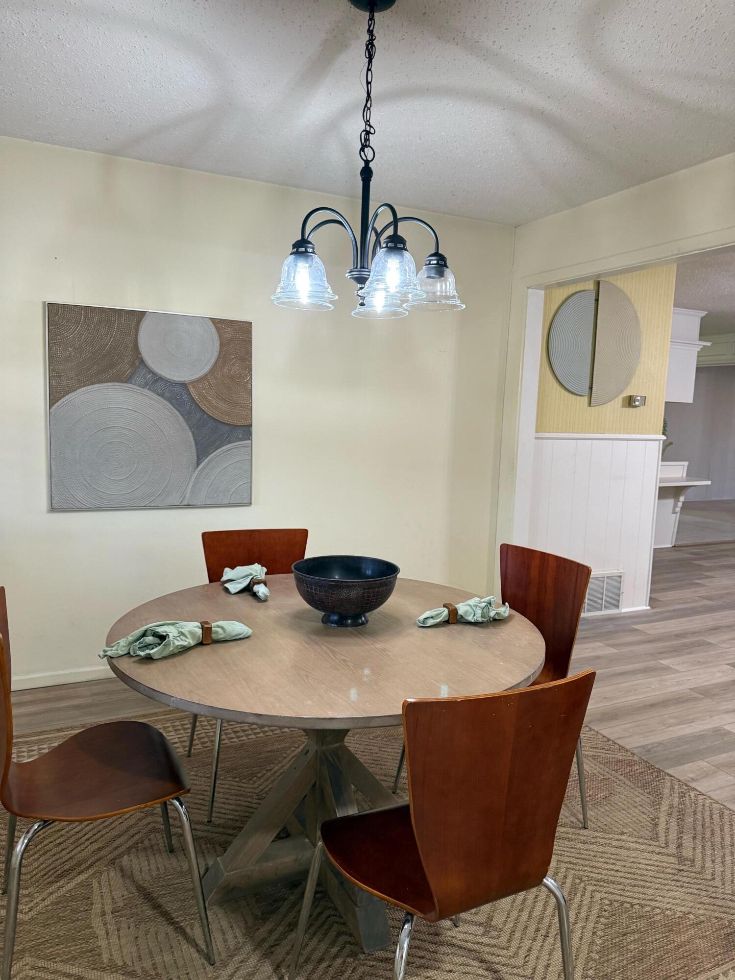 3012 69th Street Lubbock, TX 79413 - Photo 10 of 38 a view of a dining room with furniture and wooden floor