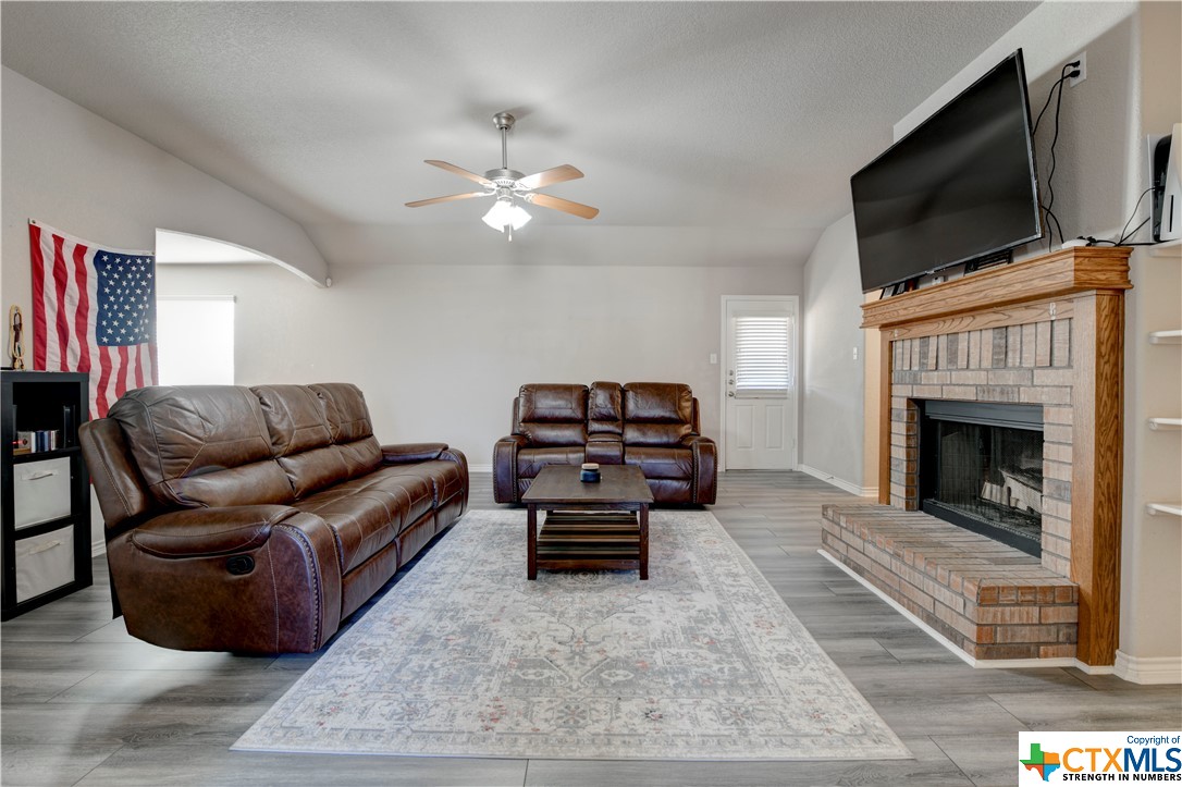 2808 Montague County Drive Killeen, TX 76549 - Photo 3 of 7 a living room with furniture a flat screen tv and a fireplace