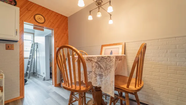 a view of a room with furniture and wooden floor