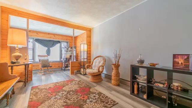 a living room with furniture a rug and a painting on the wall