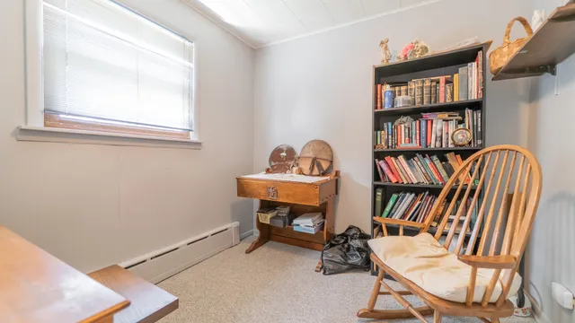 a view of a workspace with furniture and a book shelf
