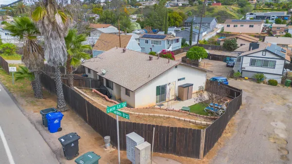 an aerial view of a house with pool table and chairs