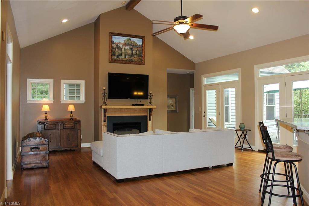8267 Coldwater Road Stokesdale, NC 27357 - Photo 3 of 30 Spacious Living Room offers Hardwood Floors, Vaulted Ceiling w/Fan Light & Lots of Light from the Double Doors!