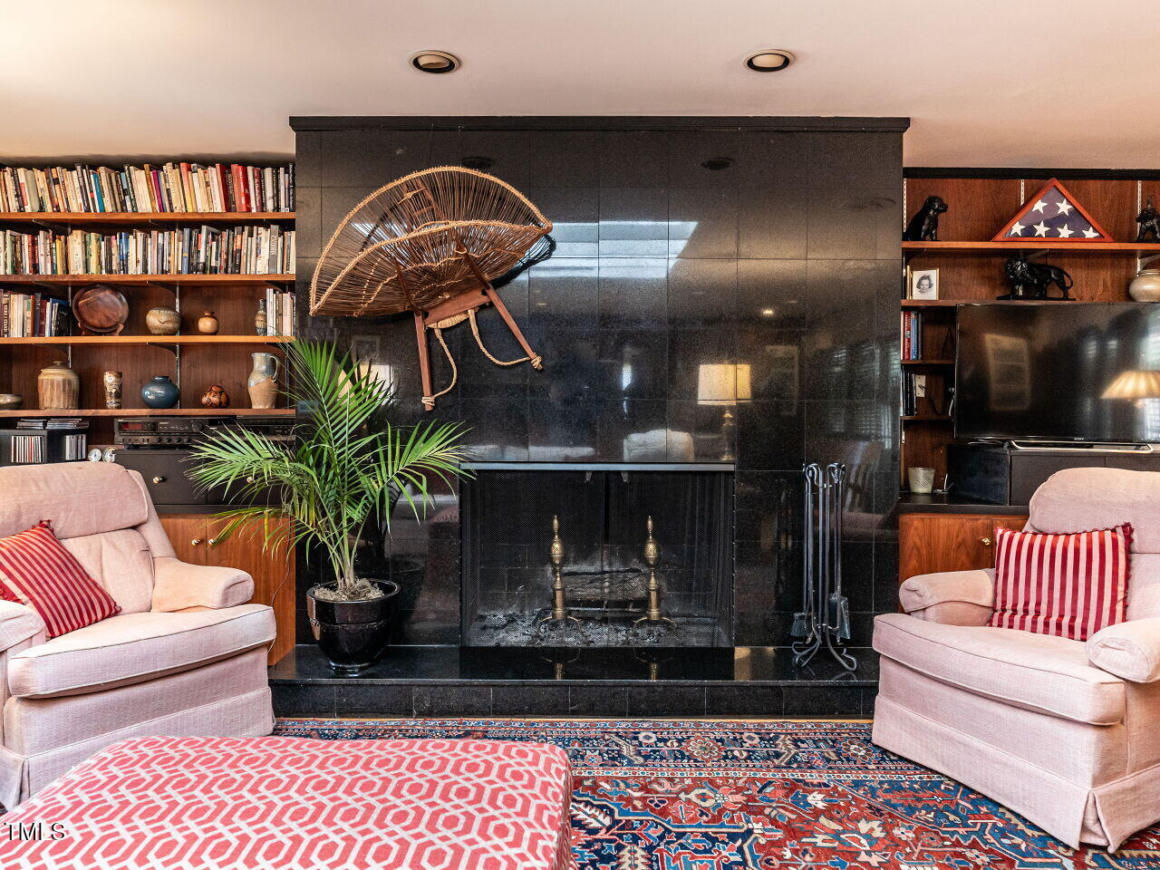 3206 Sussex Road Raleigh, NC 27612 - Photo 20 of 51 a living room with furniture a rug and a fireplace