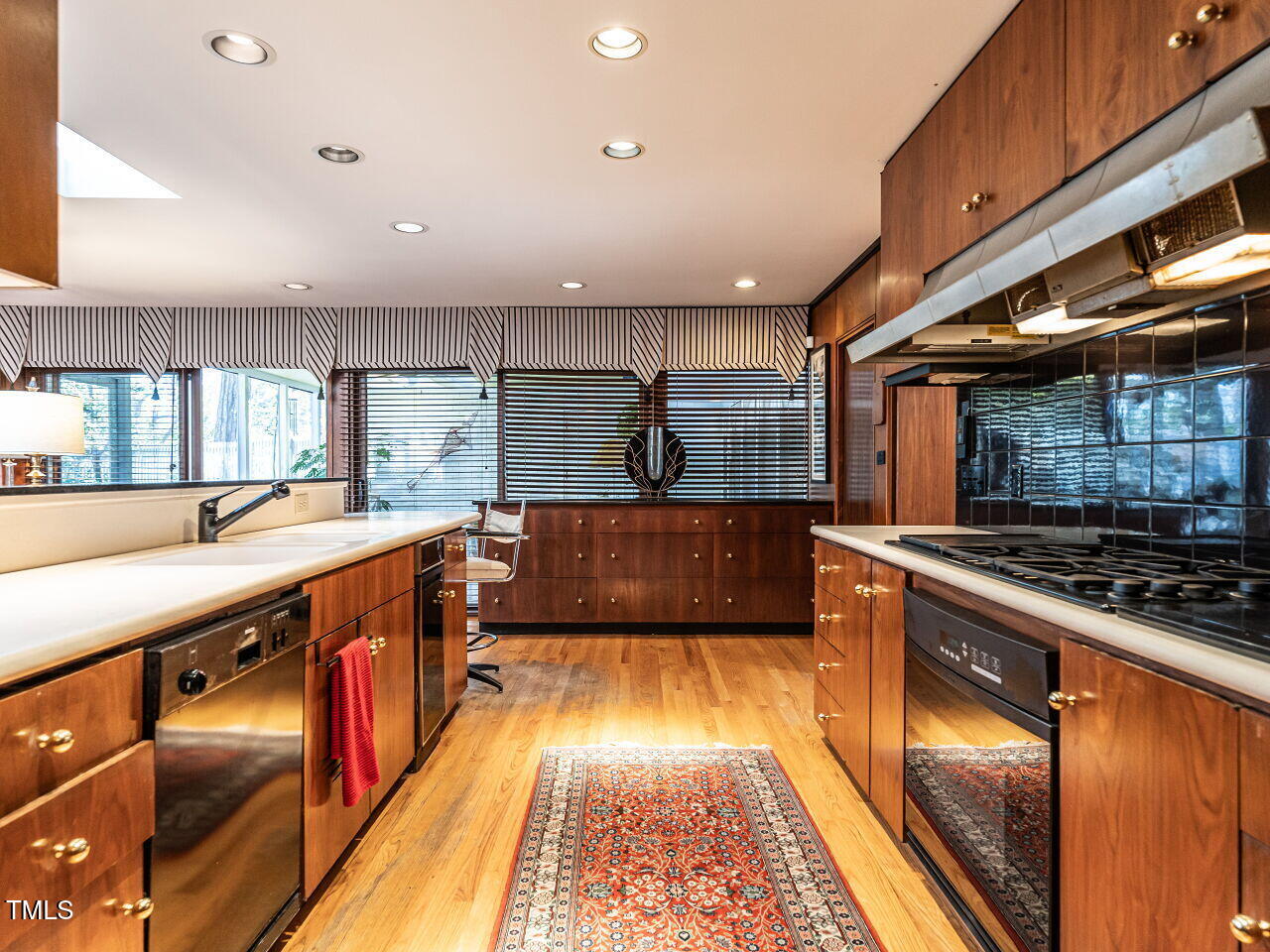 3206 Sussex Road Raleigh, NC 27612 - Photo 26 of 51 a kitchen with stainless steel appliances granite countertop a stove a sink and a refrigerator