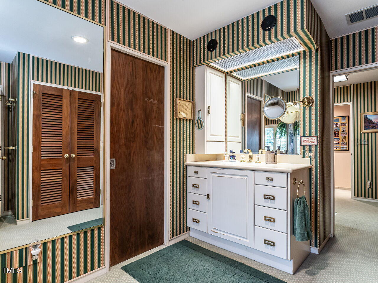 3206 Sussex Road Raleigh, NC 27612 - Photo 33 of 51 a bathroom with a sink a mirror and a bathtub