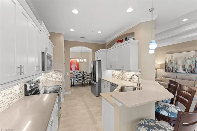 a large white kitchen with a large window