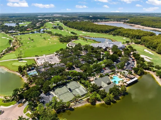 an aerial view of a house with outdoor space and lake view
