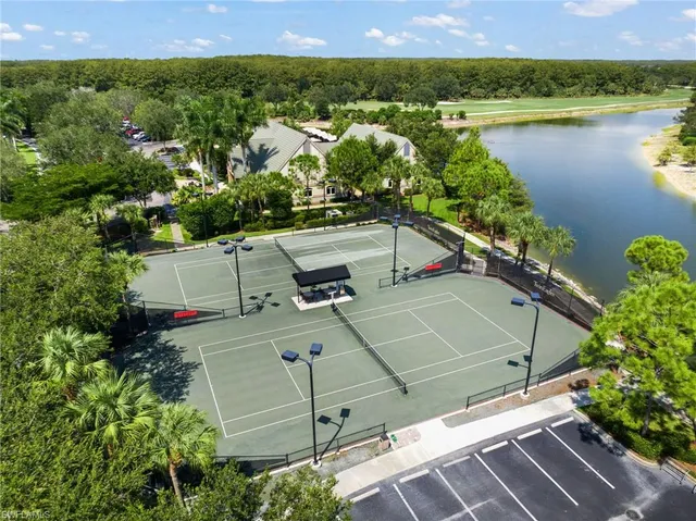 an aerial view of residential houses with outdoor space and lake view