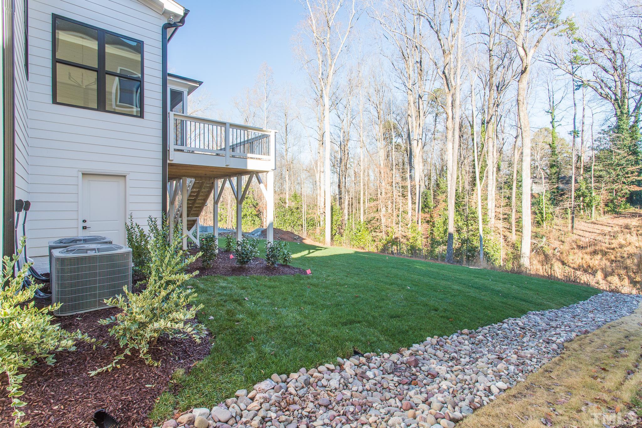 3820 Noremac Drive Raleigh, NC 27612 - Photo 16 of 46 a front view of a house with a garden and plants