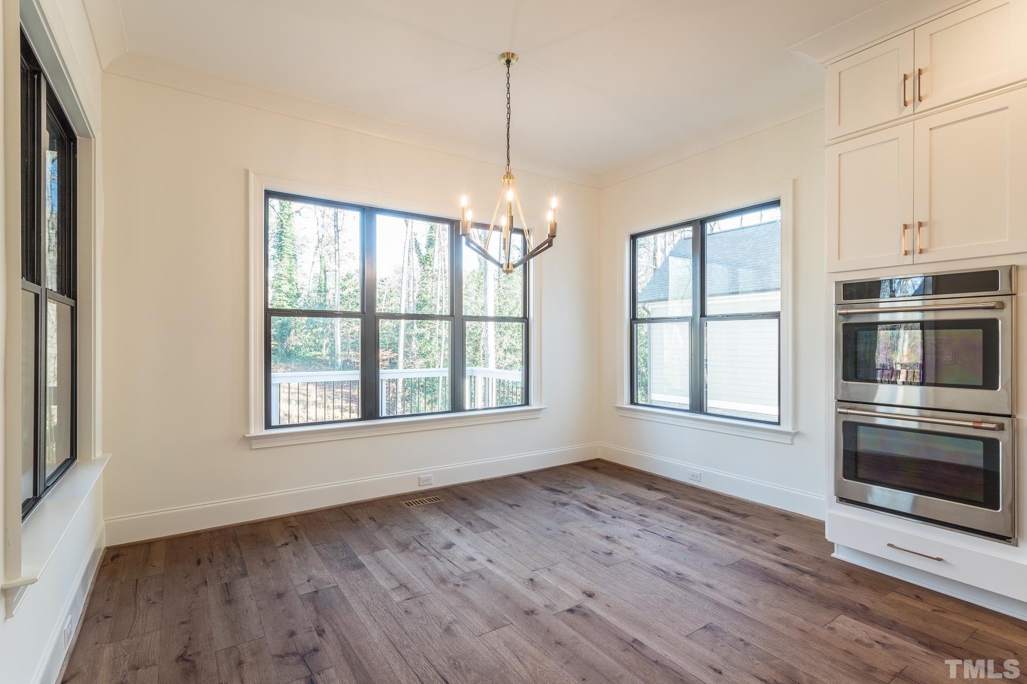3820 Noremac Drive Raleigh, NC 27612 - Photo 19 of 46 a view of an empty room with a window and wooden floor