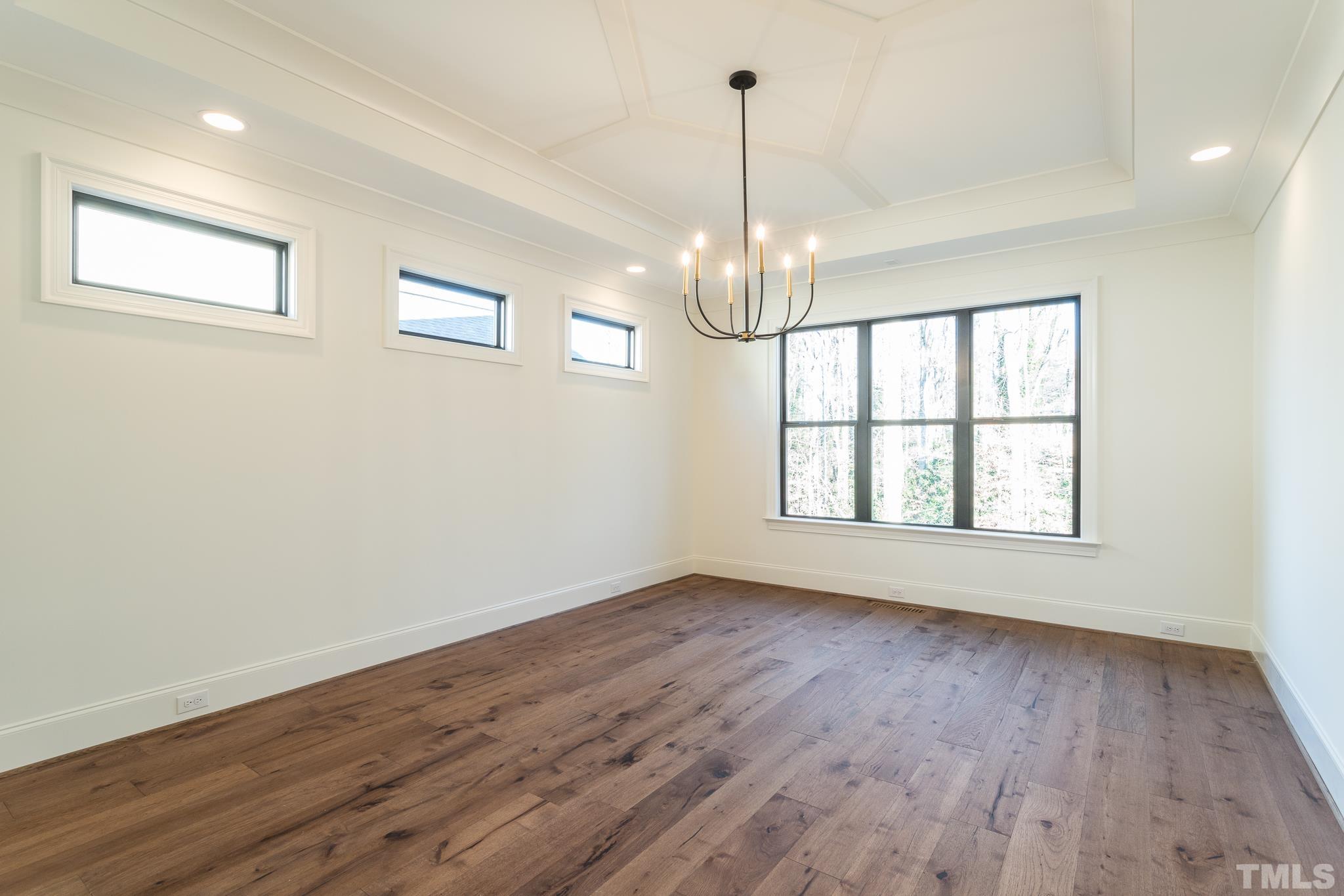 3820 Noremac Drive Raleigh, NC 27612 - Photo 22 of 46 a view of an empty room with wooden floor and a window
