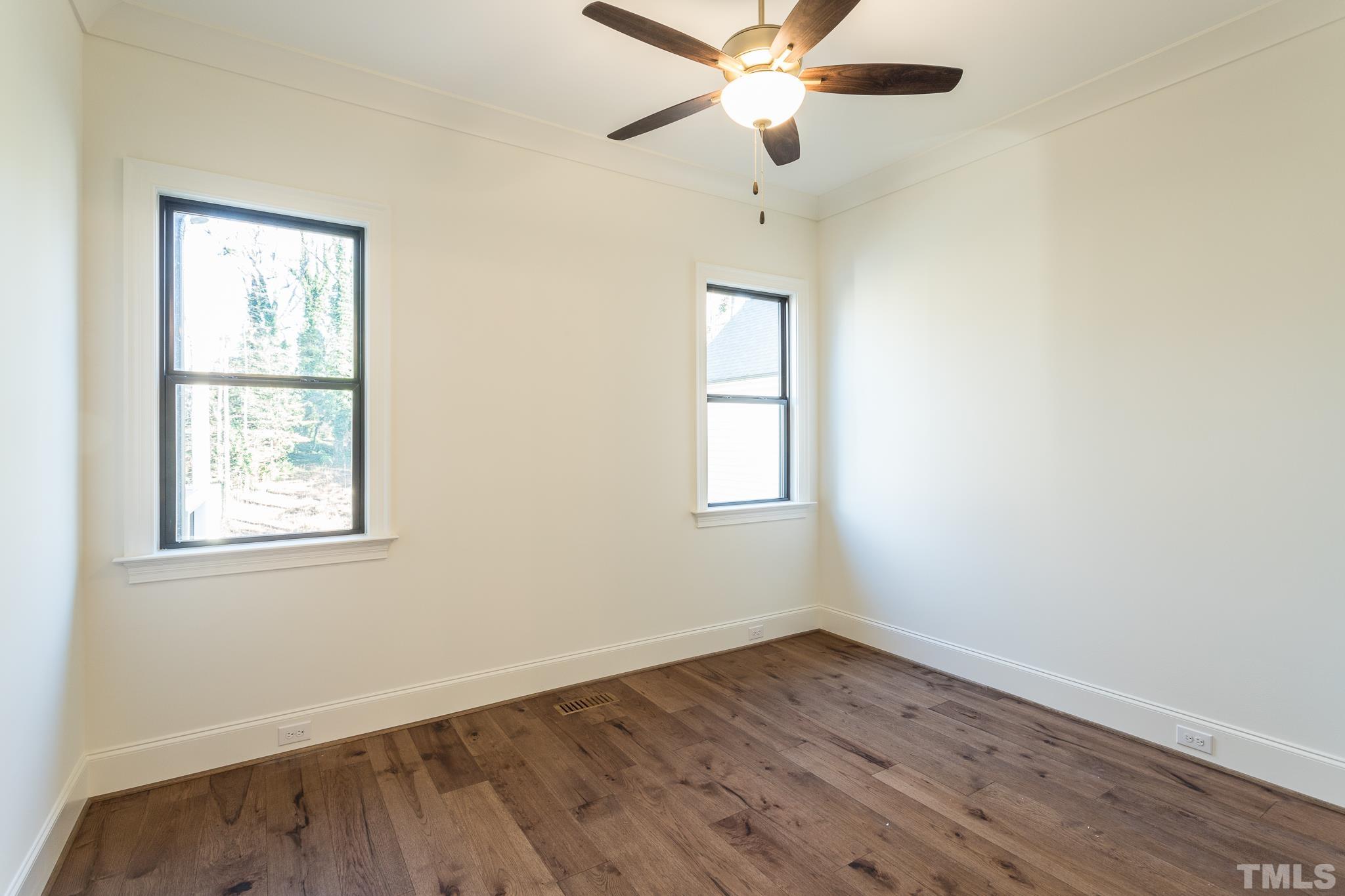 3820 Noremac Drive Raleigh, NC 27612 - Photo 27 of 46 an empty room with wooden floor fan and windows