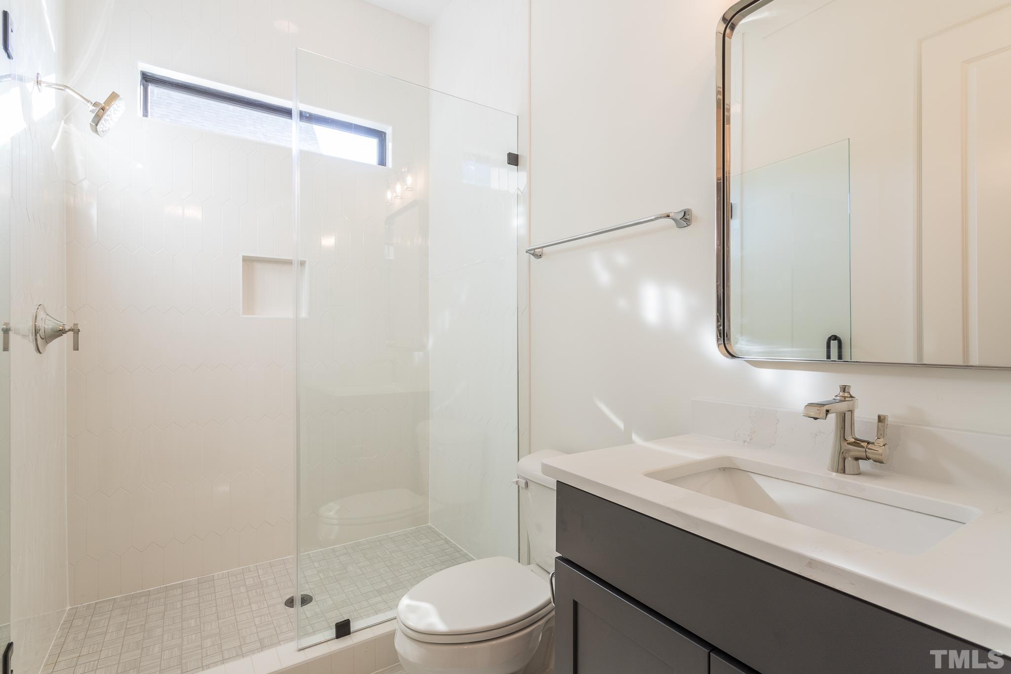 3820 Noremac Drive Raleigh, NC 27612 - Photo 28 of 46 a bathroom with a sink a toilet and shower