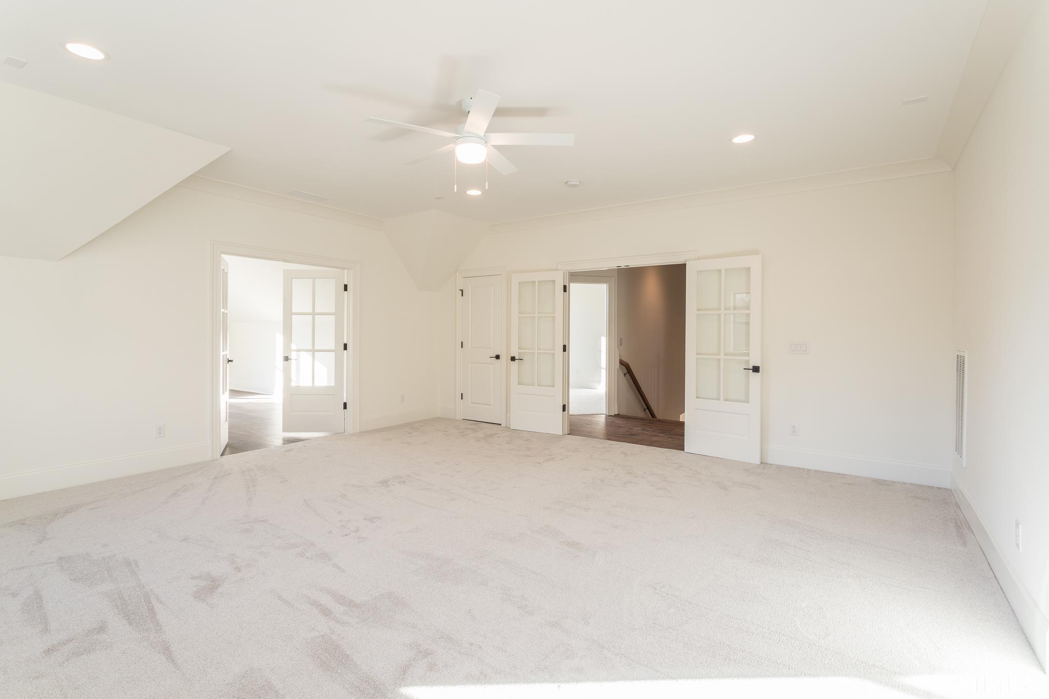 3820 Noremac Drive Raleigh, NC 27612 - Photo 30 of 46 an empty room with an entryway and fan