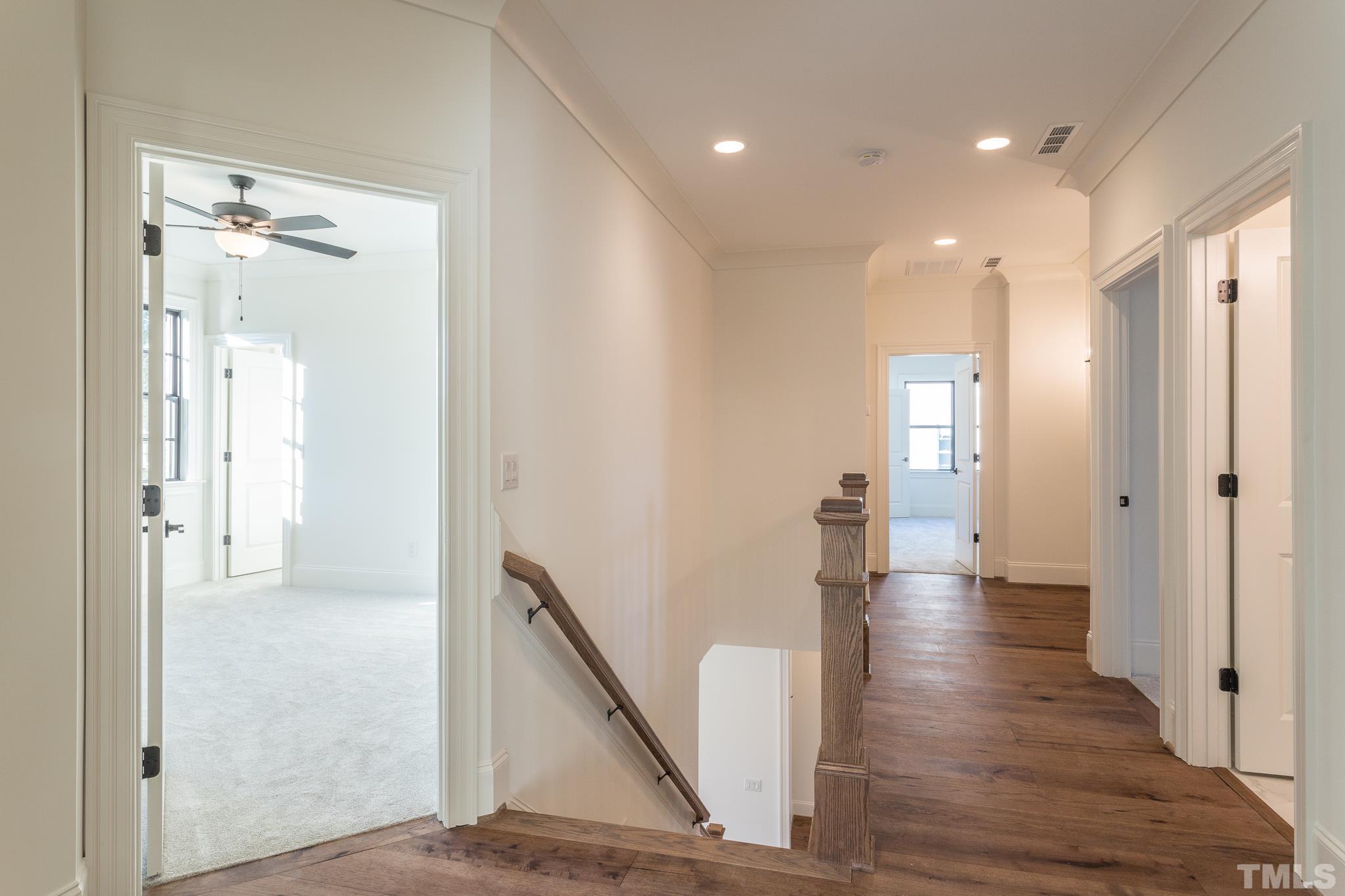 3820 Noremac Drive Raleigh, NC 27612 - Photo 34 of 46 a view of a hallway with wooden floor and staircase