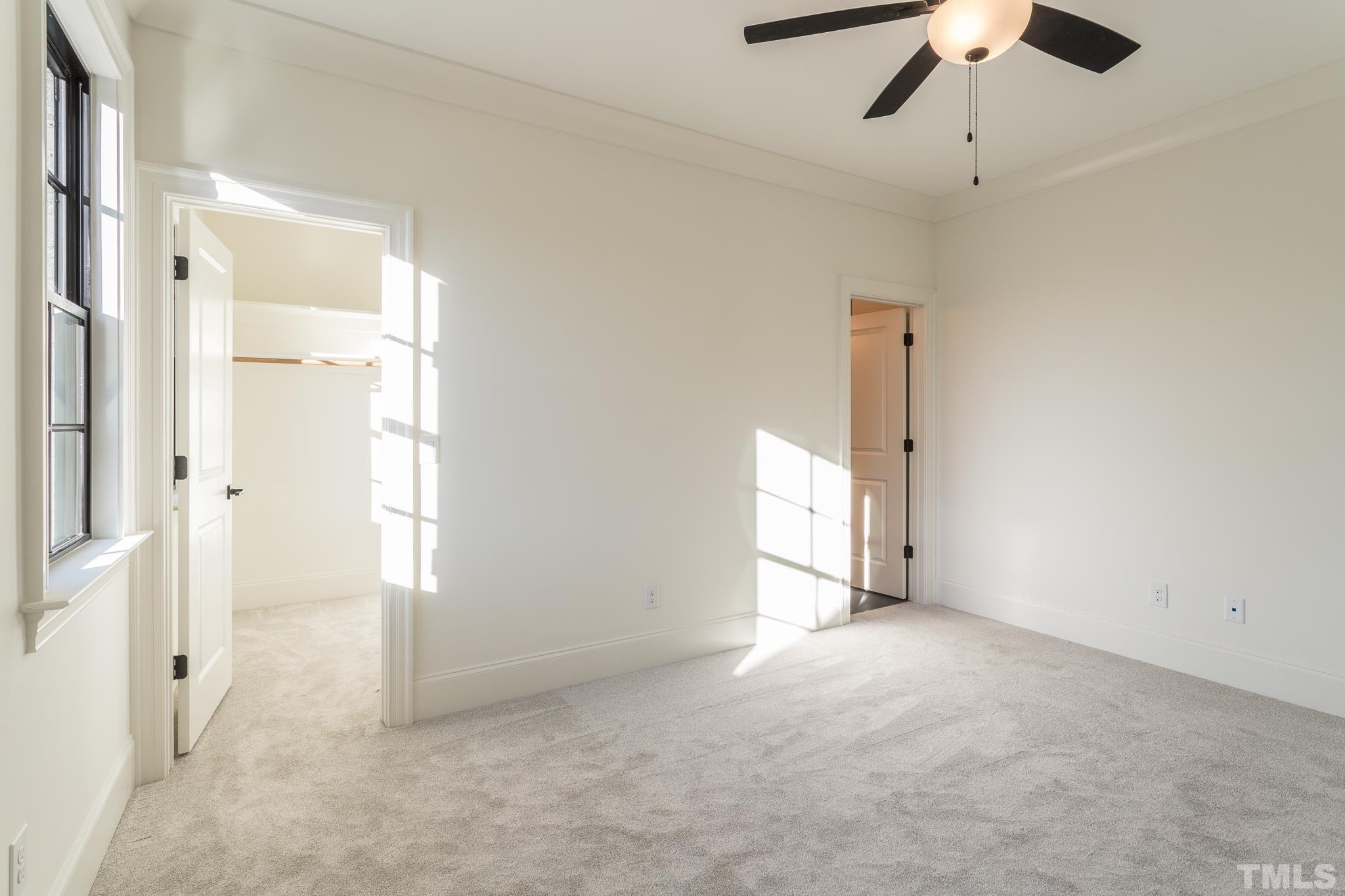 3820 Noremac Drive Raleigh, NC 27612 - Photo 36 of 46 en empty room with windows and ceiling fan
