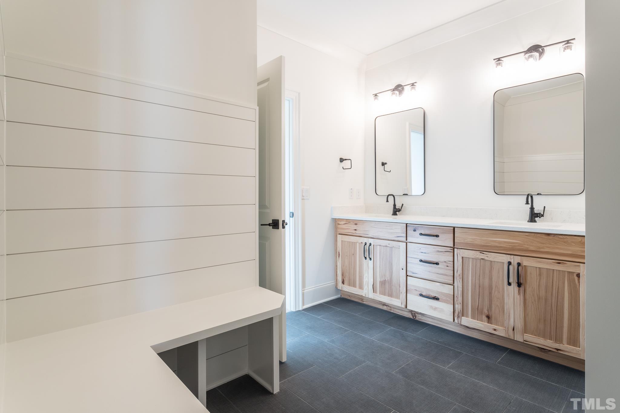 3820 Noremac Drive Raleigh, NC 27612 - Photo 38 of 46 a spacious bathroom with double vanity and a mirror