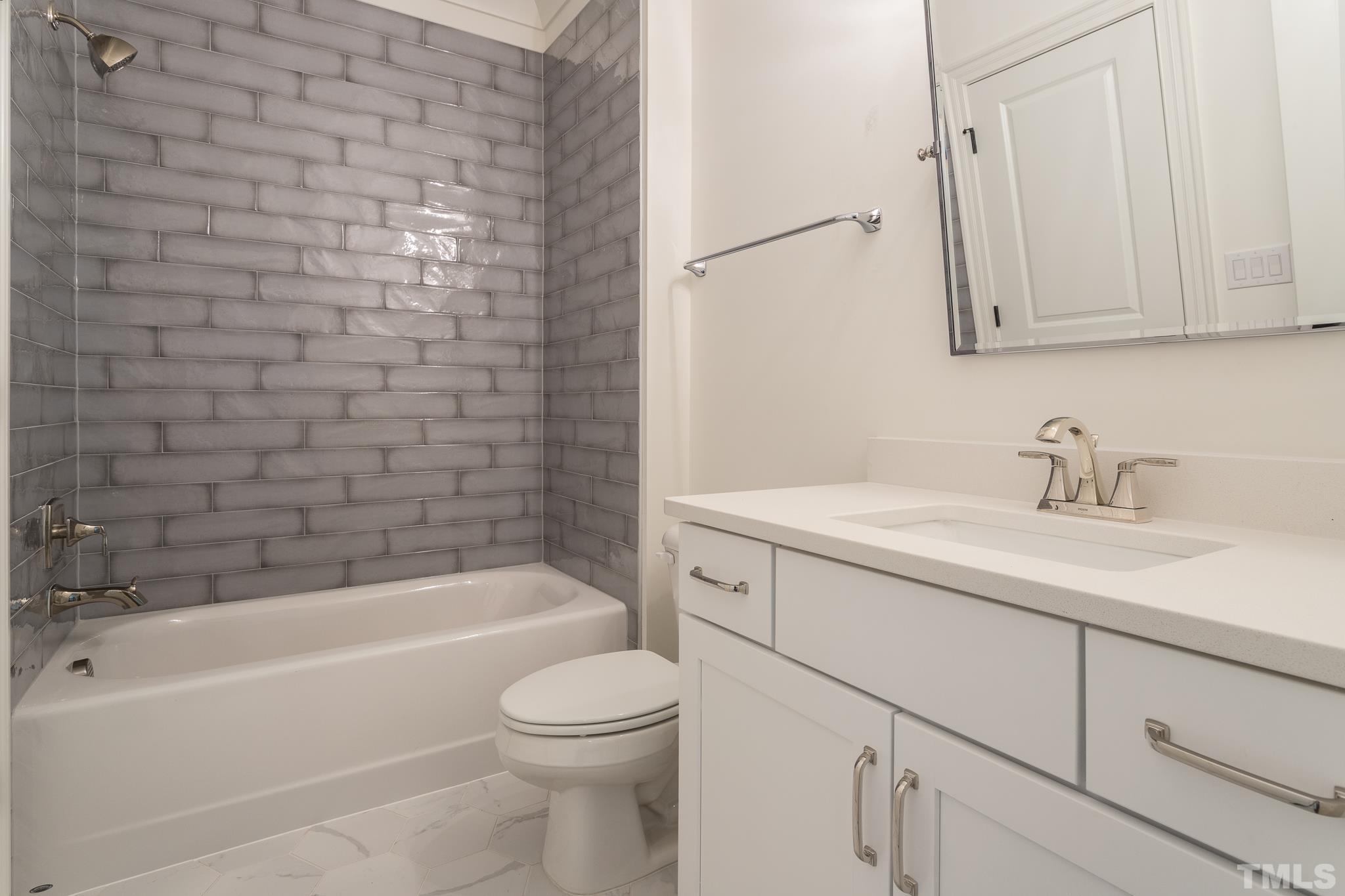 3820 Noremac Drive Raleigh, NC 27612 - Photo 44 of 46 a bathroom with a granite countertop sink a toilet and bathtub