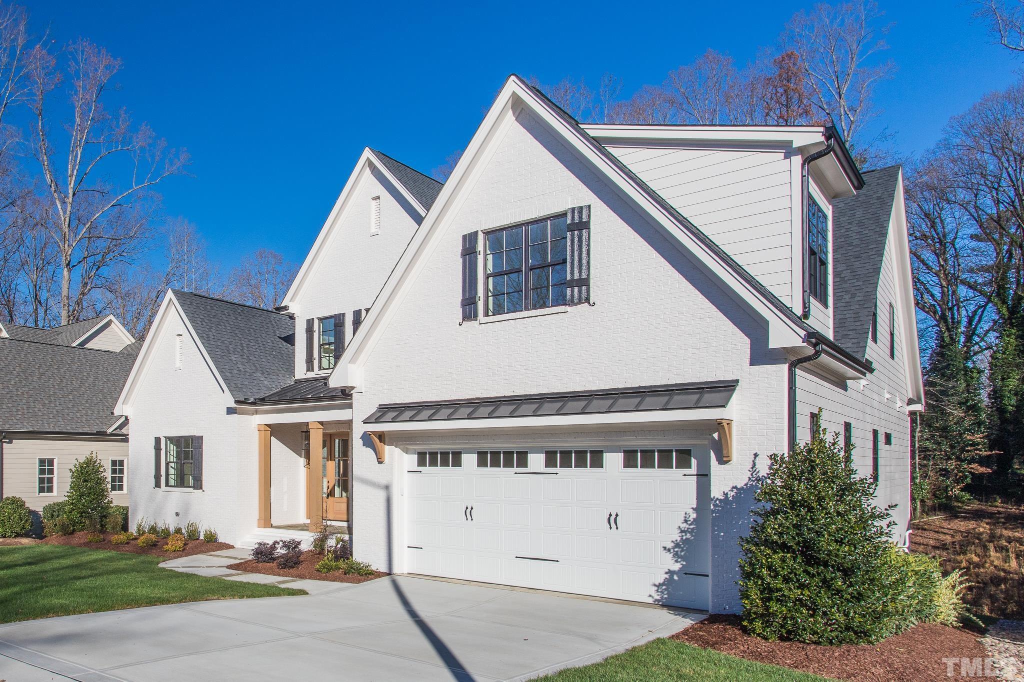 3820 Noremac Drive Raleigh, NC 27612 - Photo 45 of 46 a view of a white house with a large windows and plants