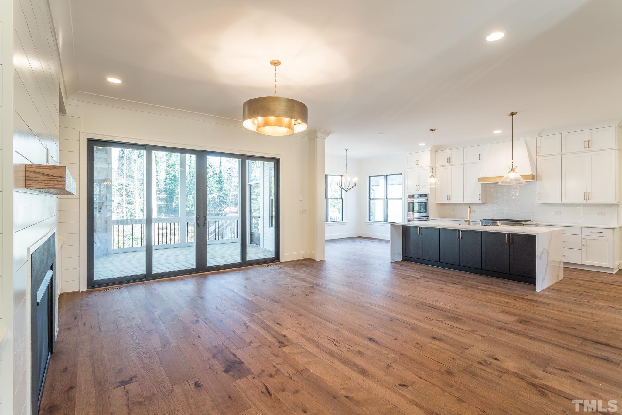 3820 Noremac Drive Raleigh, NC 27612 - Photo 9 of 46 a view of a kitchen with stainless steel appliances granite countertop a stove top oven a sink and a wooden floors