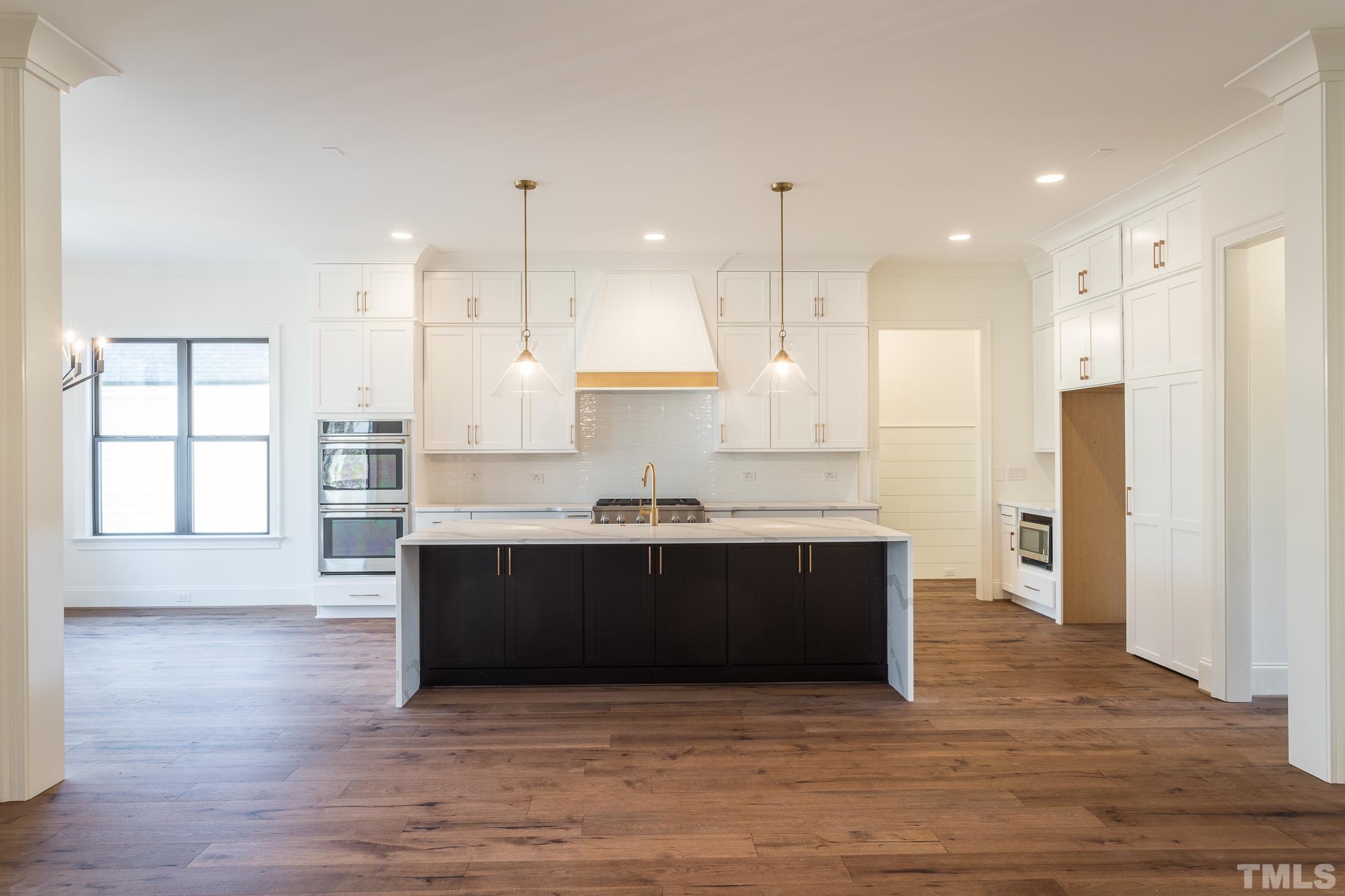 3820 Noremac Drive Raleigh, NC 27612 - Photo 10 of 46 a large kitchen with stainless steel appliances granite countertop a stove a sink and a refrigerator