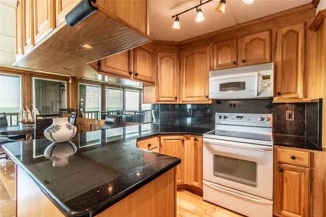 a kitchen with stainless steel appliances granite countertop a sink and cabinets