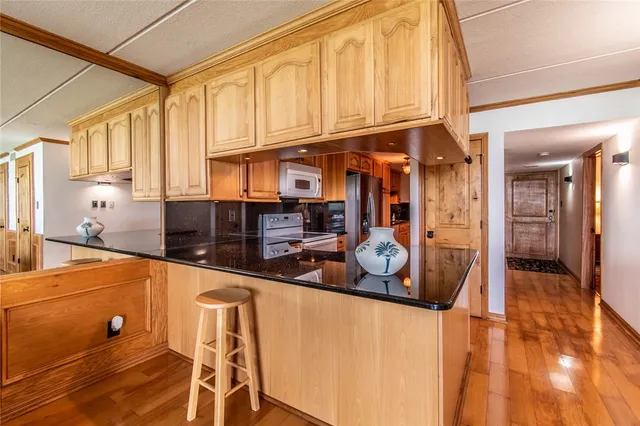 a living room with furniture floor to ceiling window and a flat screen tv