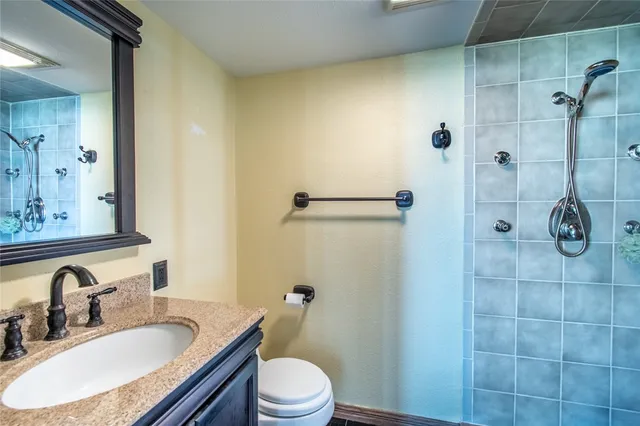 a bedroom with a bed and a lamp on the dresser