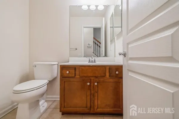 a bathroom with a toilet a sink and mirror