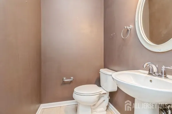 a white toilet sitting next to a bathroom sink