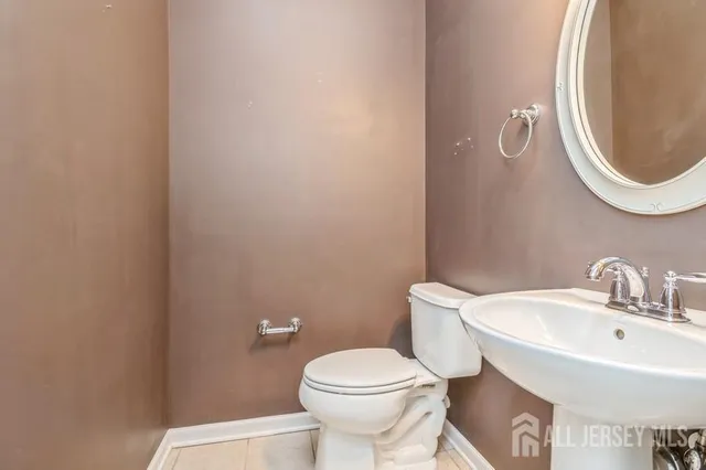 a white toilet sitting next to a bathroom sink