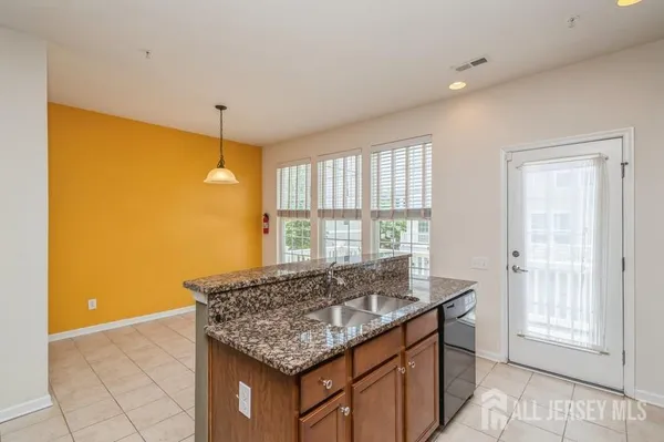 a kitchen with stainless steel appliances granite countertop a sink and a granite counter tops