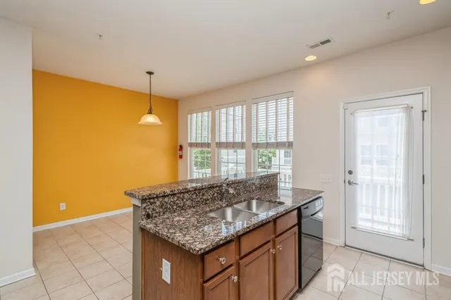 a kitchen with stainless steel appliances granite countertop a sink and a granite counter tops