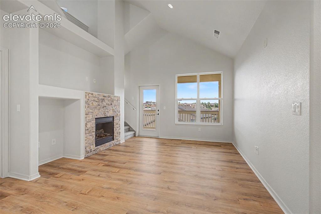 5353 Palomino Ranch Point, Unit 307 Colorado Springs, CO 80922 - Photo 16 of 30 Vaulted ceilings, stacked stone fireplace, ample natural light