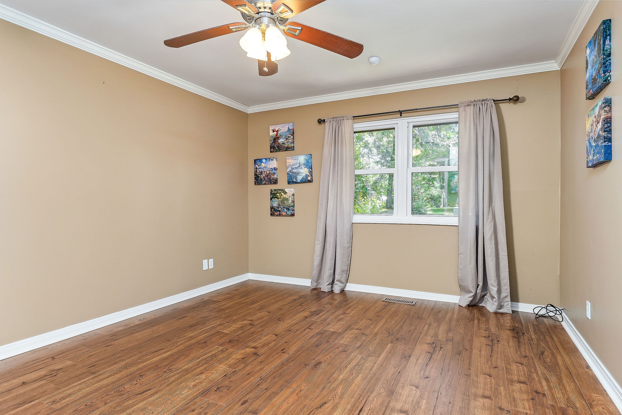 727 Timber Lane Cookeville, TN 38501 - Photo 14 of 68 an empty room with wooden floor chandelier fan and windows