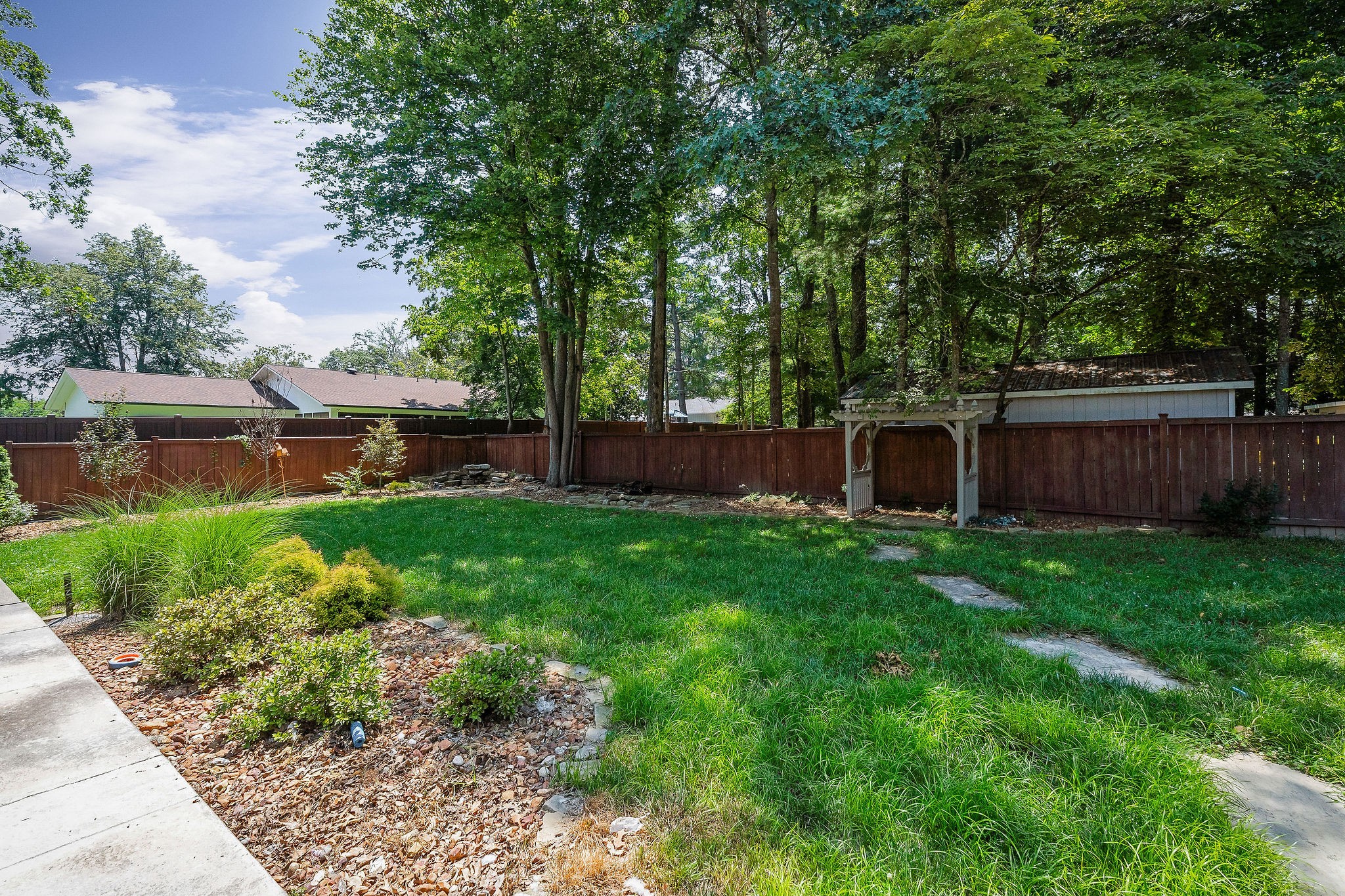 727 Timber Lane Cookeville, TN 38501 - Photo 49 of 68 a view of a backyard with table and chairs and wooden fence