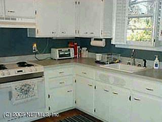 4669 Martingale Road Jacksonville, FL 32210 - Photo 3 of 5 a kitchen with stainless steel appliances granite countertop a sink stove and cabinets