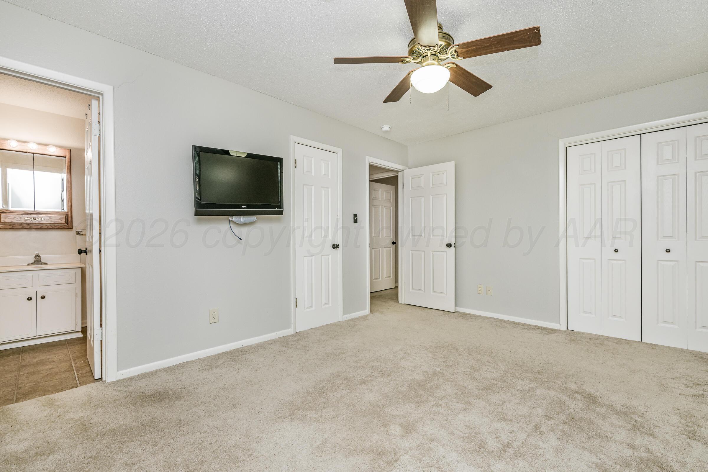 4400 West Farmers Avenue Amarillo, TX 79110 - Photo 26 of 27 an empty room with closet and a flat screen tv