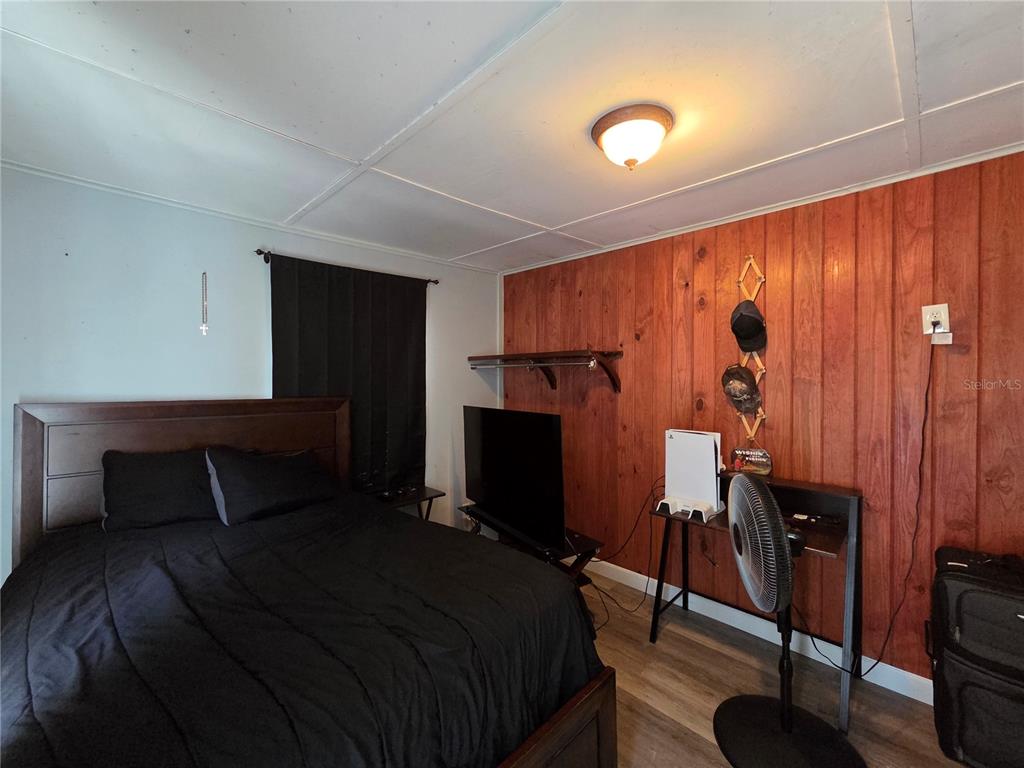 124 East F Street Frostproof, FL 33843 - Photo 24 of 37 a bedroom with a bed and a flat screen tv