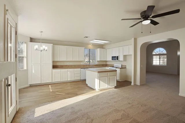a kitchen with stainless steel appliances granite countertop a stove a sink and a microwave
