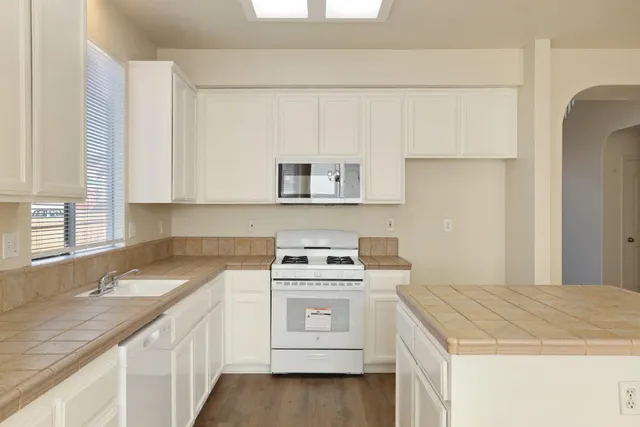 a view of a kitchen with a sink and a fireplace