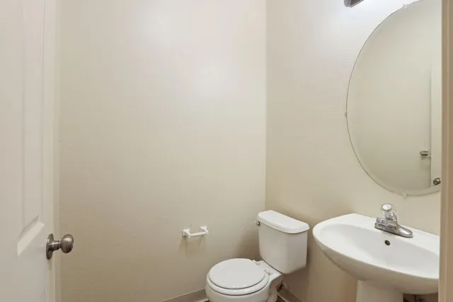 a view of an empty room with a chandelier fan