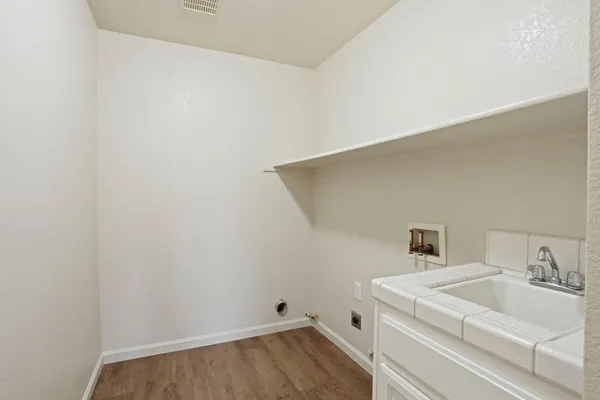 an empty room with a ceiling fan and windows