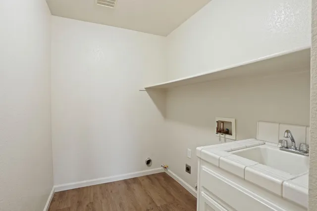 an empty room with a ceiling fan and windows