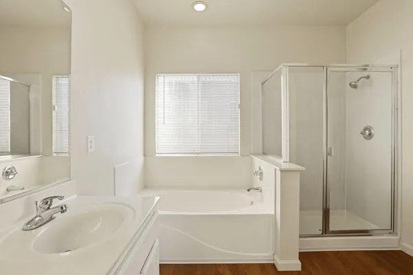 a bathroom with double vanity sinks a vanity a lamp and a mirror