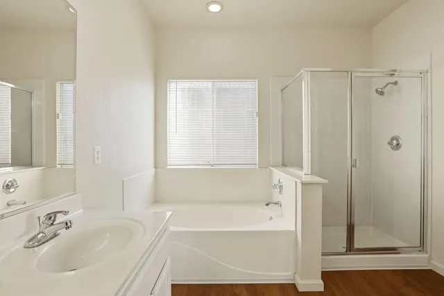 a bathroom with double vanity sinks a vanity a lamp and a mirror
